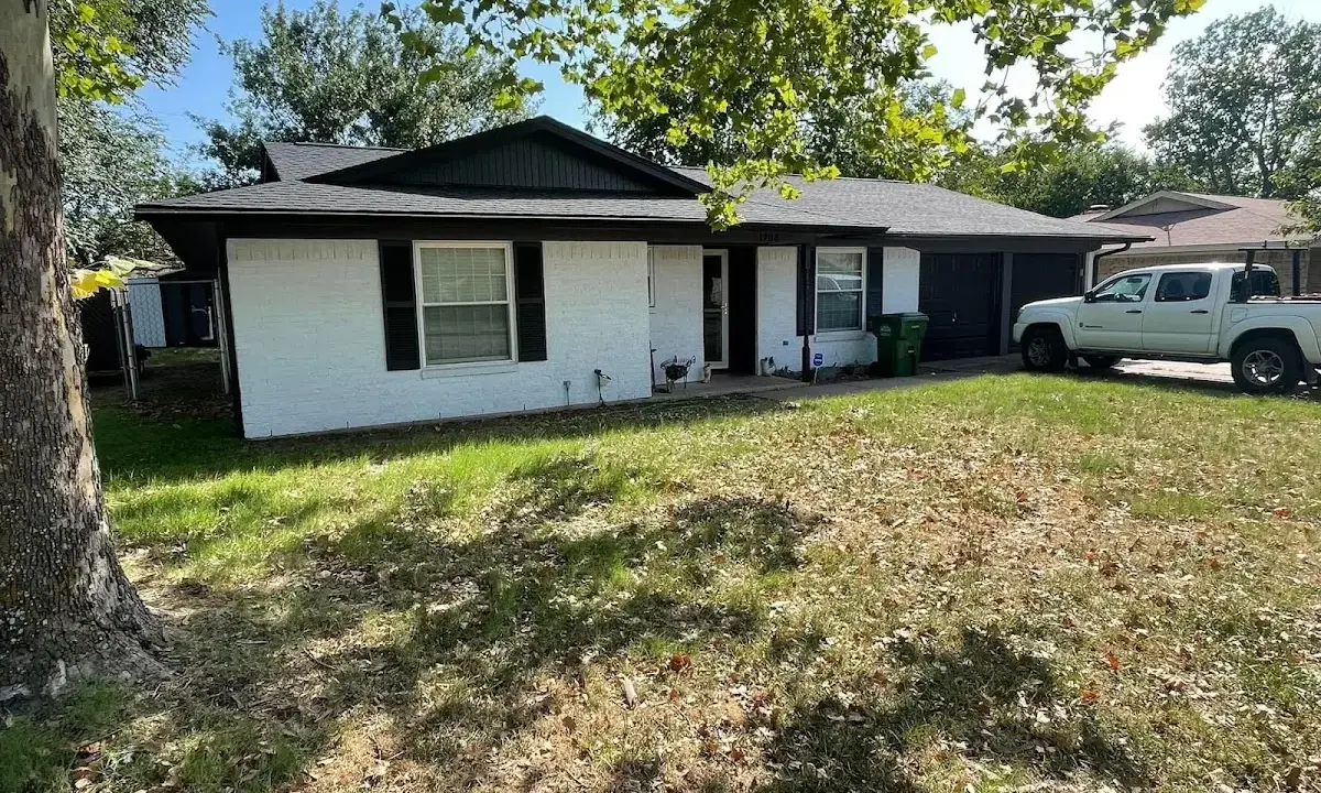 Professional roofing crew working on a residential roof in Fairmont